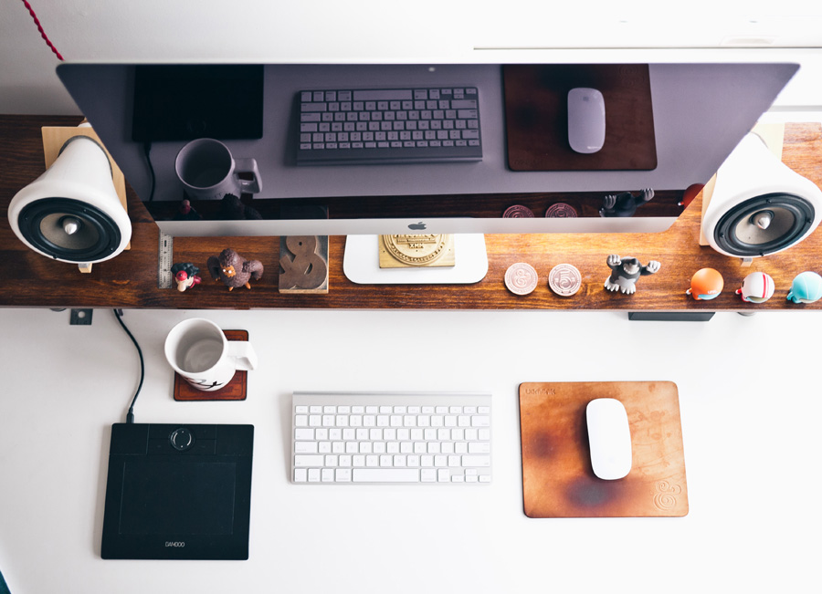 overview shot of a desk with a desktop computer, mouse and keyboard